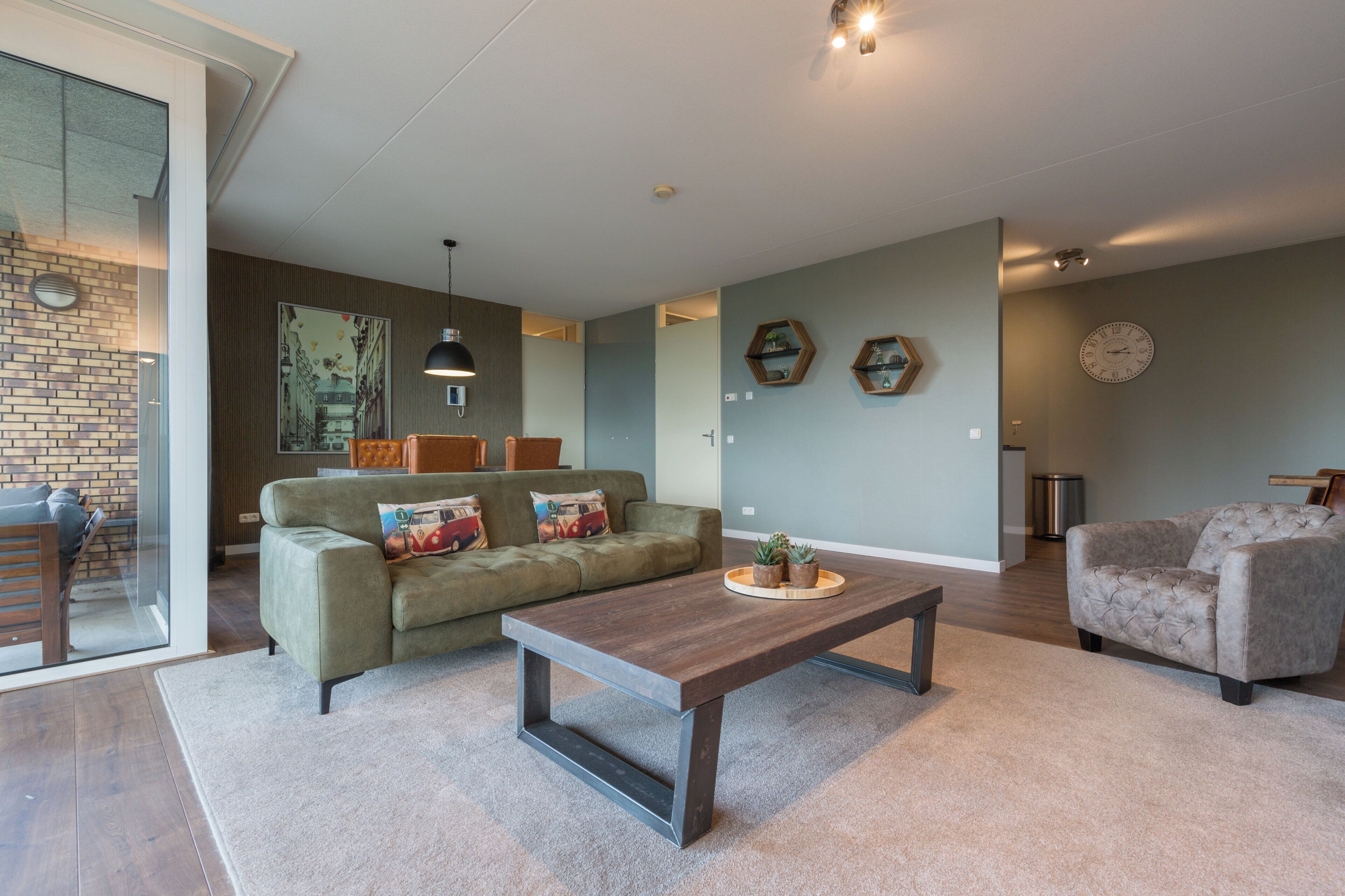 A modern living room with a sofa, coffee table, and decorative items.