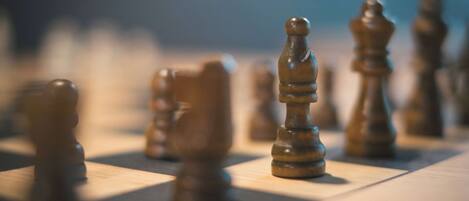 A close-up of wooden chess pieces on a chessboard.