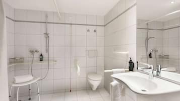 A modern bathroom with a shower, toilet, and sink.
