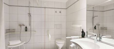 A modern bathroom with a shower, toilet, and sink.
