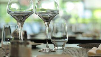 A table set with wine glasses, plates, and cutlery, indicating a dining area.