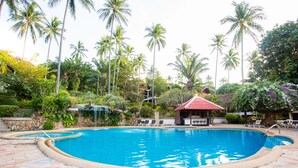 A swimming pool with lounge chairs and a small gazebo, surrounded by palm trees and lush greenery. - Nova Samui Resort (Koh Samui)