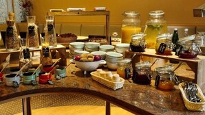 Un bufé de desayuno con una variedad de alimentos y acompañamientos.