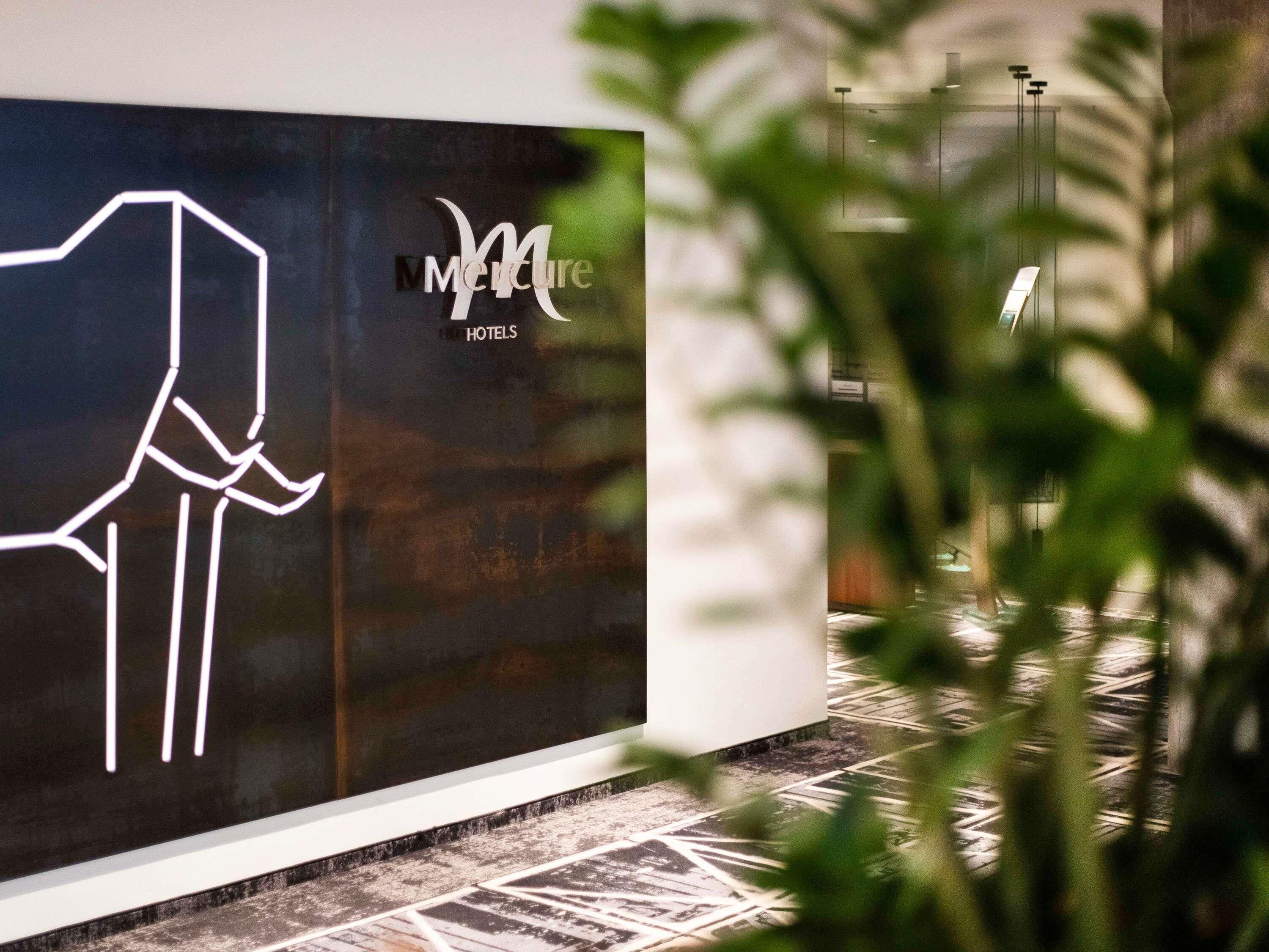 A hotel sign with a stylized 'M' logo and the text 'Merit Hotels'.