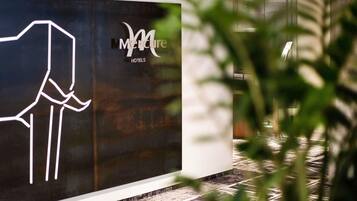 A hotel sign with a stylized 'M' logo and the text 'Merit Hotels'.