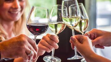A group of people toasting with wine glasses.