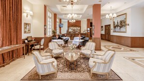 A spacious lobby with a central seating area, chandeliers, and a bar in the background. - Du Parc Hotel Dalat (Xuan Huong - Da Lat)