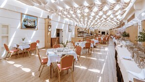 A spacious dining area with high ceilings and natural light, featuring tables set for multiple guests. - Du Parc Hotel Dalat (Xuan Huong - Da Lat)