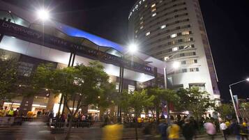 A hotel with a prominent sign reading "NOVOTEL" and a large building with multiple floors.