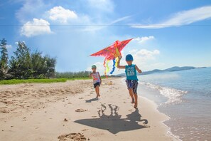 On the beach, white sand, sun-loungers, beach umbrellas