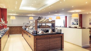 A breakfast buffet with various food items, a wooden counter, and pendant lighting. - Mercure Hotel Stuttgart Sindelfingen an der Messe (Sindelfingen)