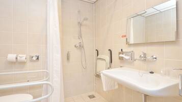 A modern bathroom with a shower, toilet, and sink.