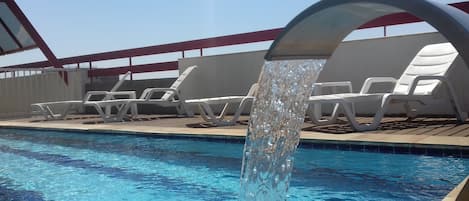 Outdoor pool, open 6:00 AM to 10:00 PM, pool loungers