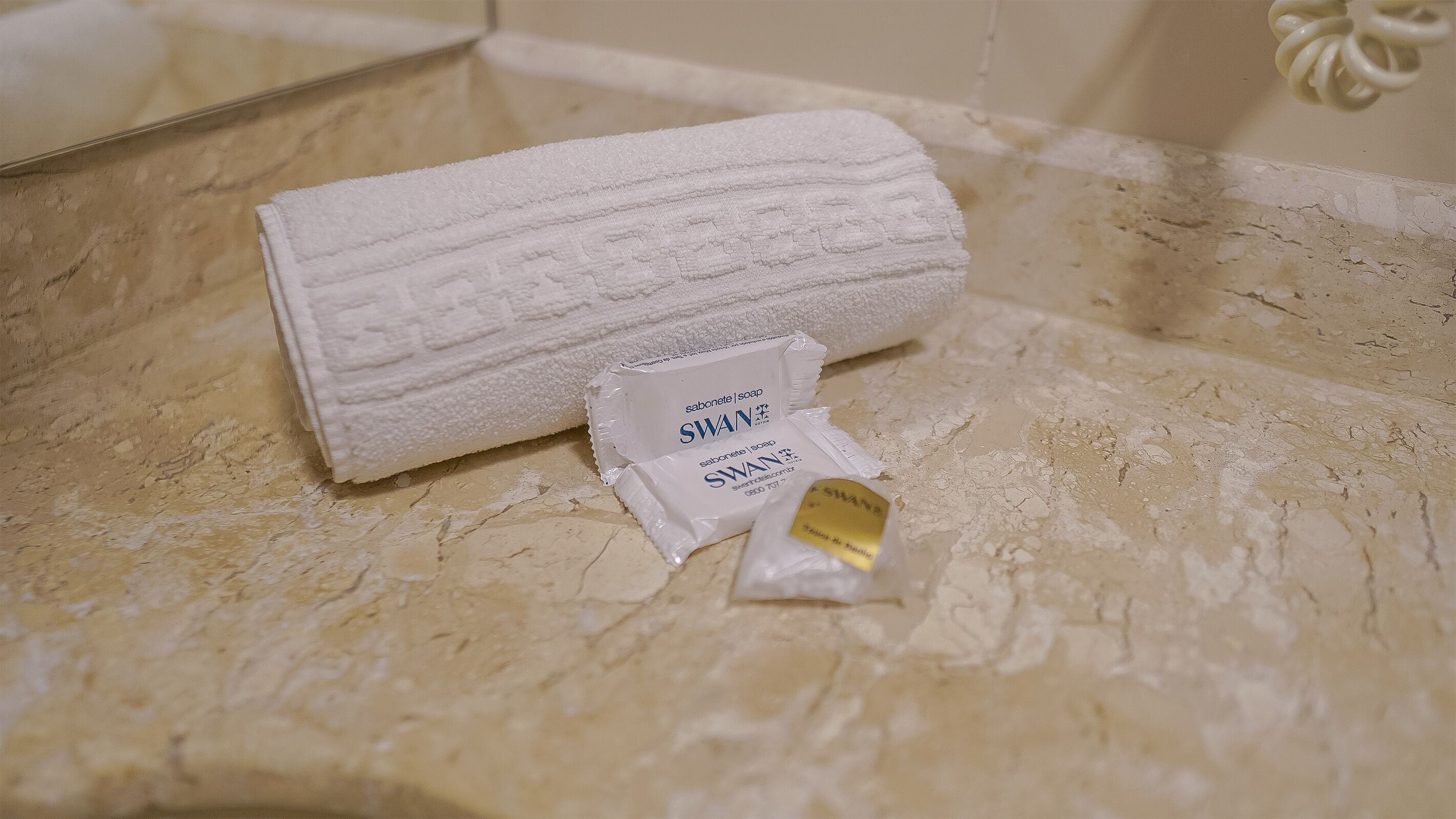 designer toiletries, hair dryer, towels, soap