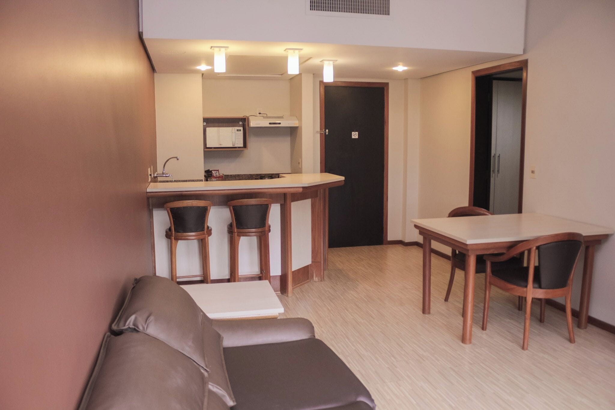 A compact living space with a kitchenette, a dining area, and a seating area.