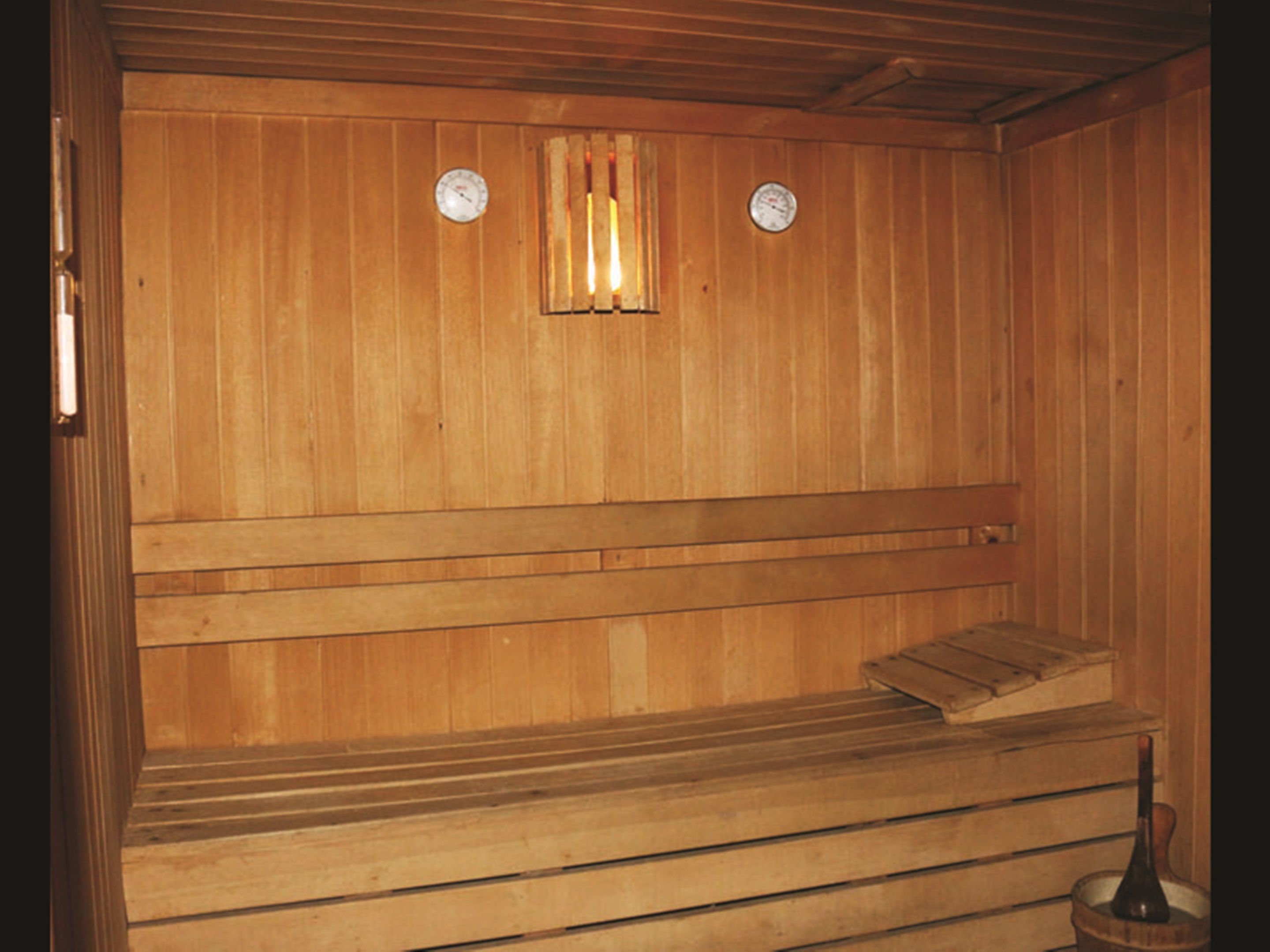 A wooden sauna with benches and a bench seat.