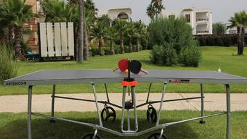 Enjoy a game of ping pong in our outdoor space, where a portable table awaits your next match.