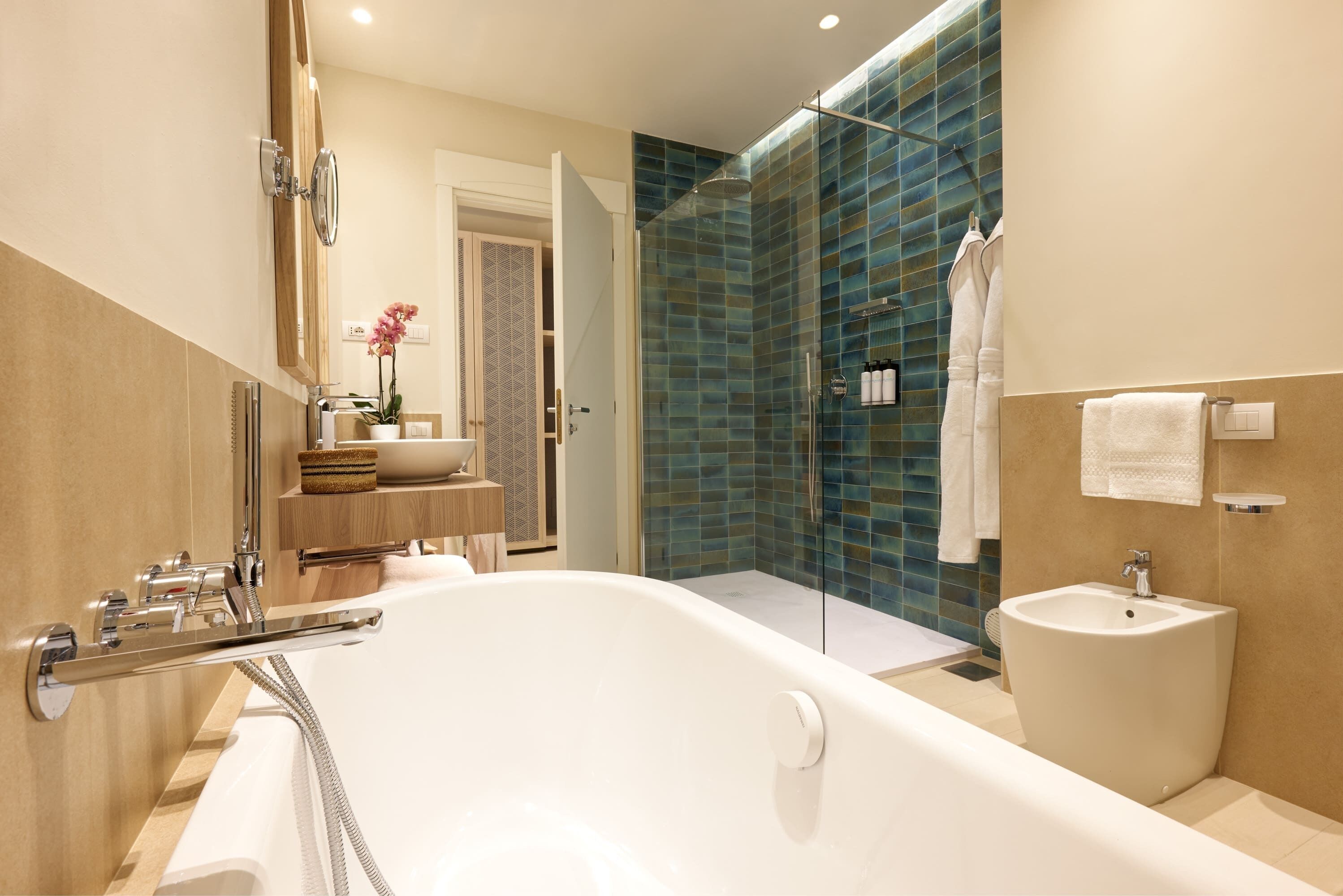 junior suite, 1 king bed with sofa bed, partial sea view | bathroom | separate bathtub and shower, rainfall showerhead, designer toiletries