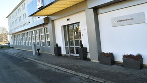A modern building with a sign reading "STOCKHOLM SOUTH" and large windows. - Good Morning+ Hägersten (Hägersten)