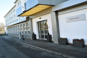 A modern building with a sign reading "STOCKHOLM SOUTH" and large windows.