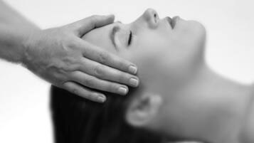 A person receiving a head massage.