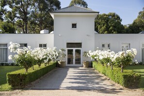 A modern building with a symmetrical facade, large windows, and a central entrance. - Lancemore Lindenderry Red Hill (Red Hill)