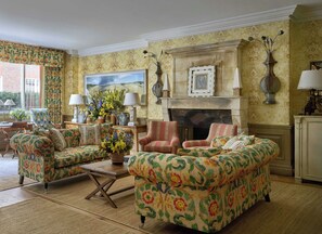 A traditional living room with patterned furniture, a fireplace, and a large painting on the wall. - Charlotte Street Hotel, Firmdale Hotels (London)