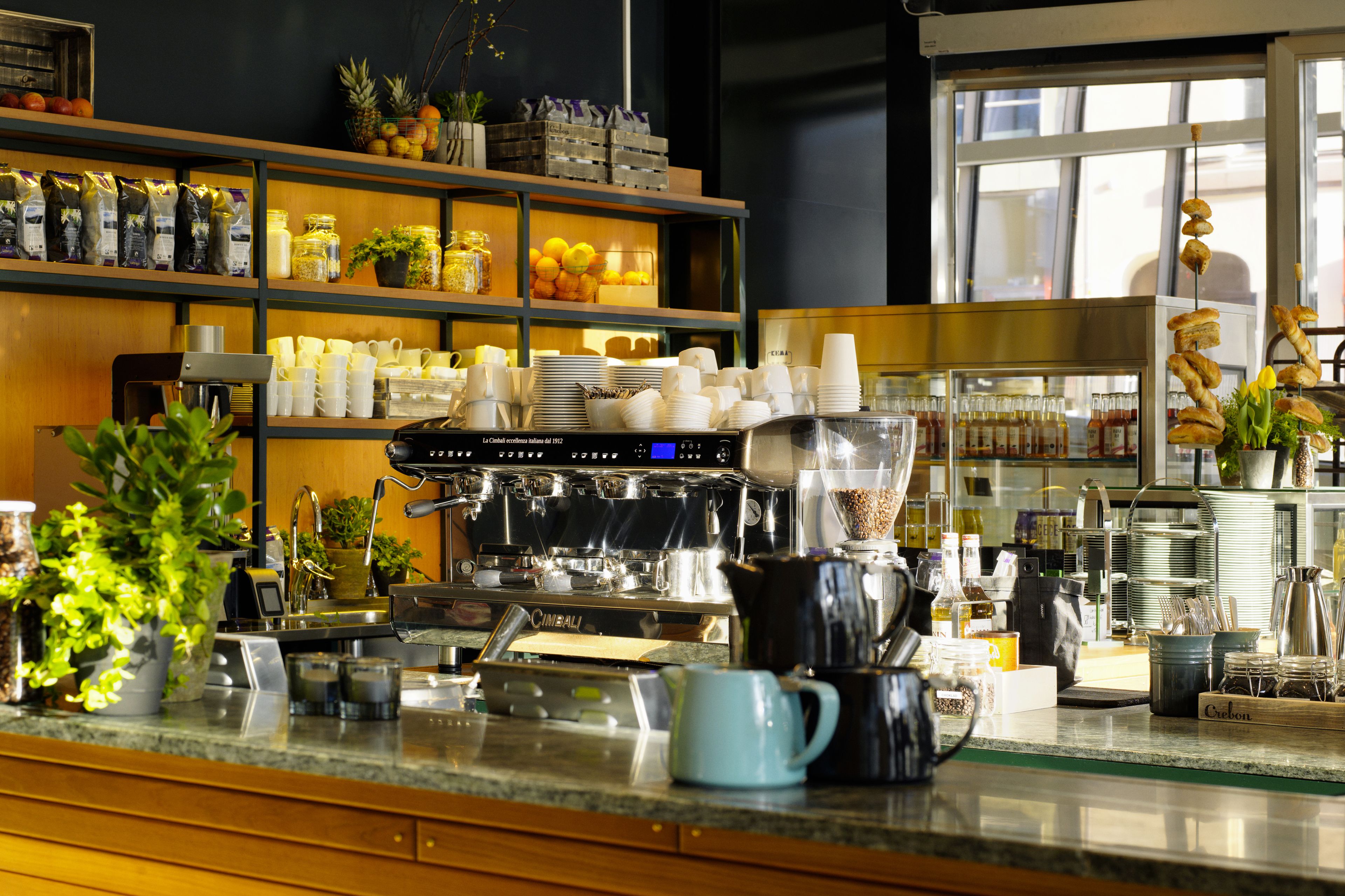 A well-organized coffee station with a coffee machine, cups, and various coffee-related items.