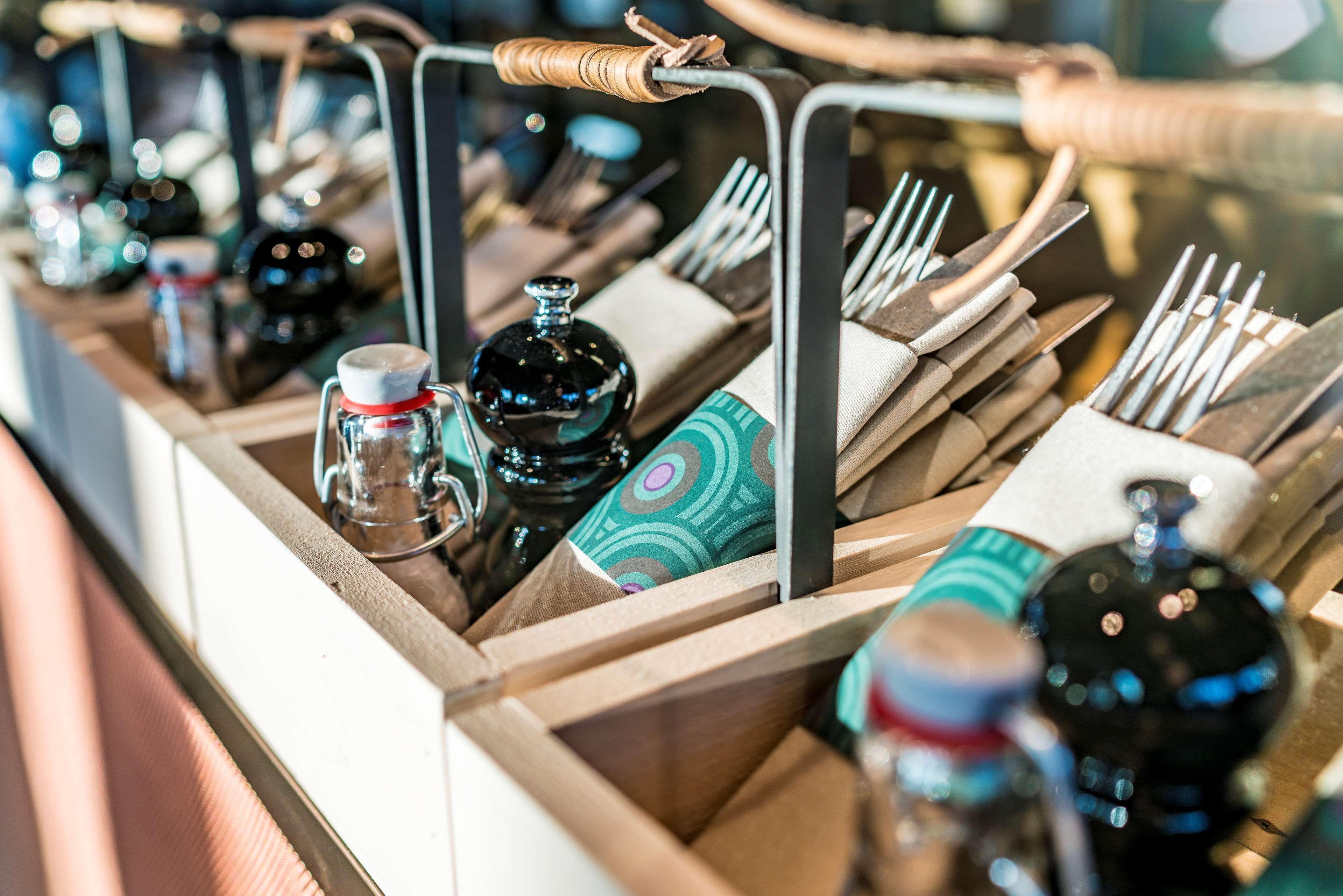 A neatly organized bar area with various bottles and utensils.