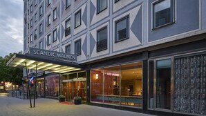 A modern hotel facade with a geometric pattern, large glass windows, and a sign reading "SCANDIC MALMEN". - Scandic Malmen (Stockholm)