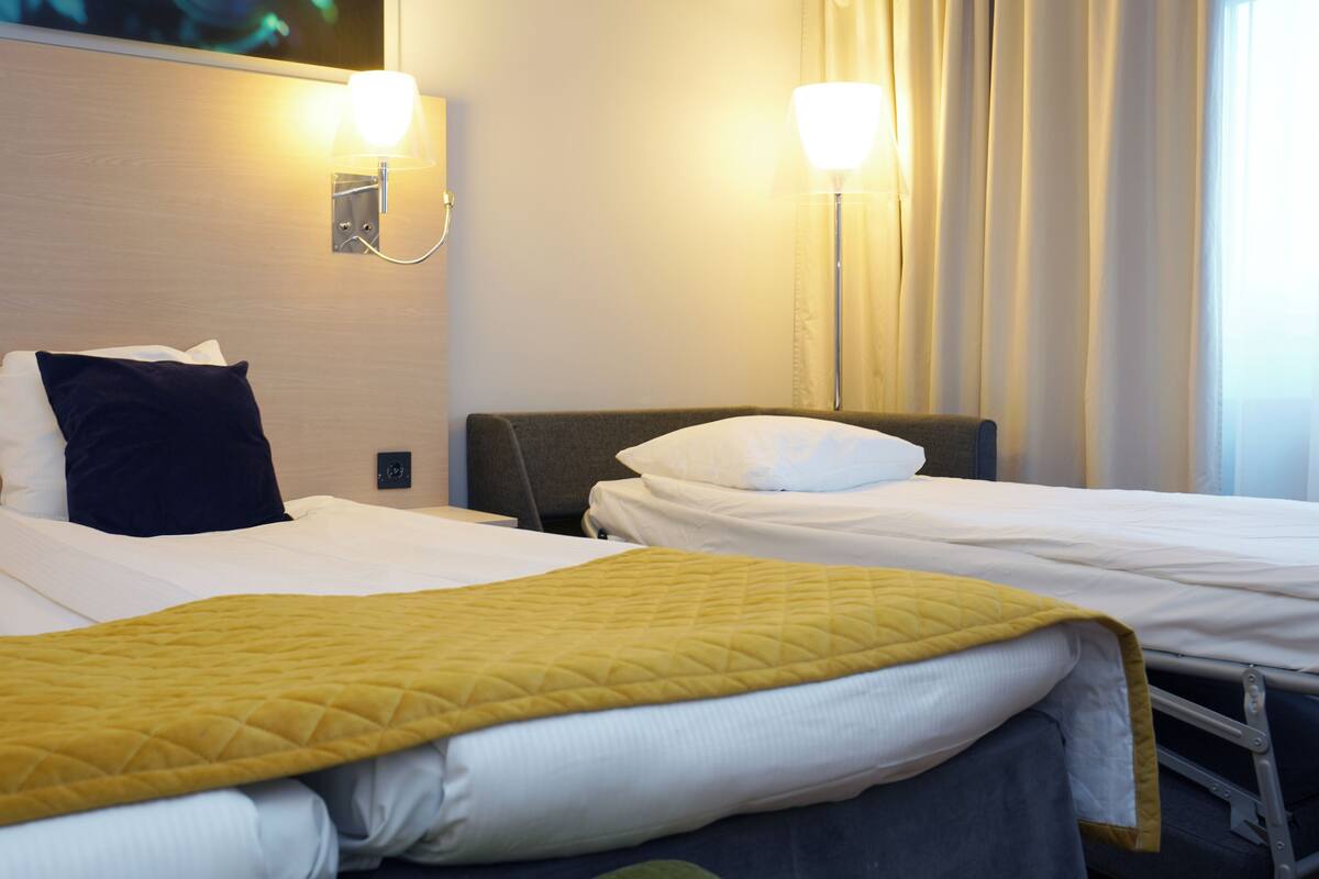 Desk, iron/ironing board, bed sheets