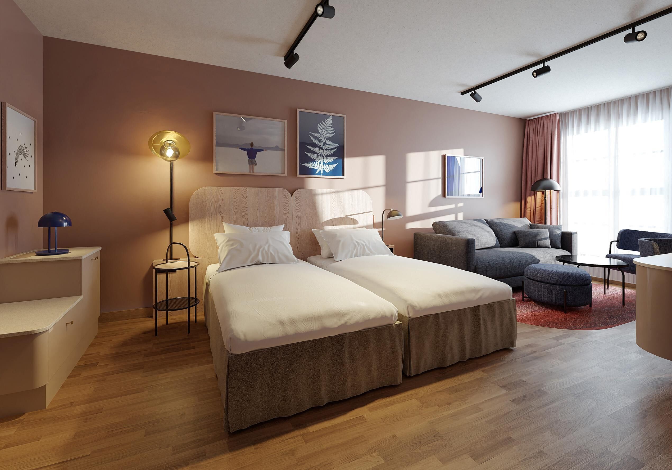 Una habitación de hotel moderna con cama, sofá y zona de escritorio.