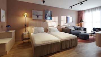 Una habitación de hotel moderna con cama, sofá y zona de escritorio.