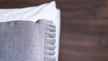 A close-up of a pillow with a textured fabric and a ribbed edge.