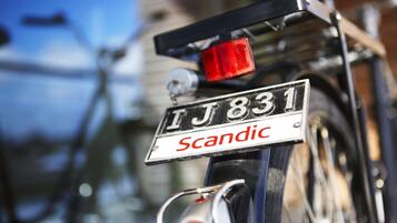 A bicycle with a license plate reading "TJ 831" and the word "Scandinavian" below it.
