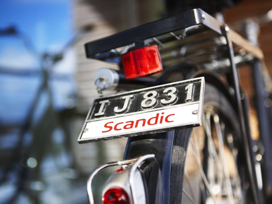 A bicycle with a license plate reading "TJ 831" and the word "Scandinavian" below it.