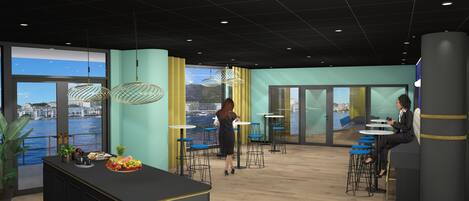 A modern office space with a large window overlooking a body of water, a central island with a fruit display, and multiple seating areas with tables and chairs.