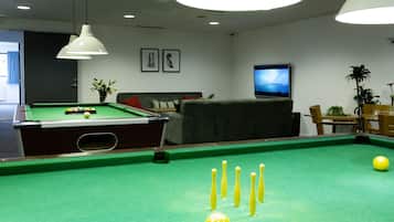 Relax by the pool, where you can play a game of pool, watch TV, or unwind on the sofa.