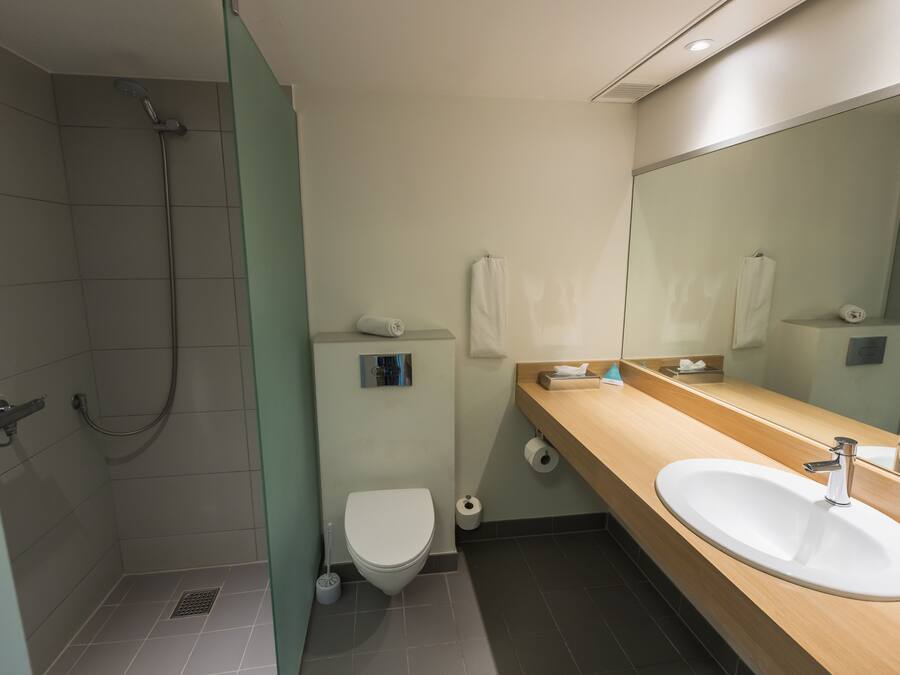 Un baño moderno con ducha, inodoro y lavamanos.