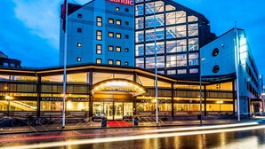 A hotel with a modern glass facade, a prominent 'Scandic' sign, and a 'Conferens Restaurant' visible at the entrance. - Scandic Skellefteå (Skelleftea)