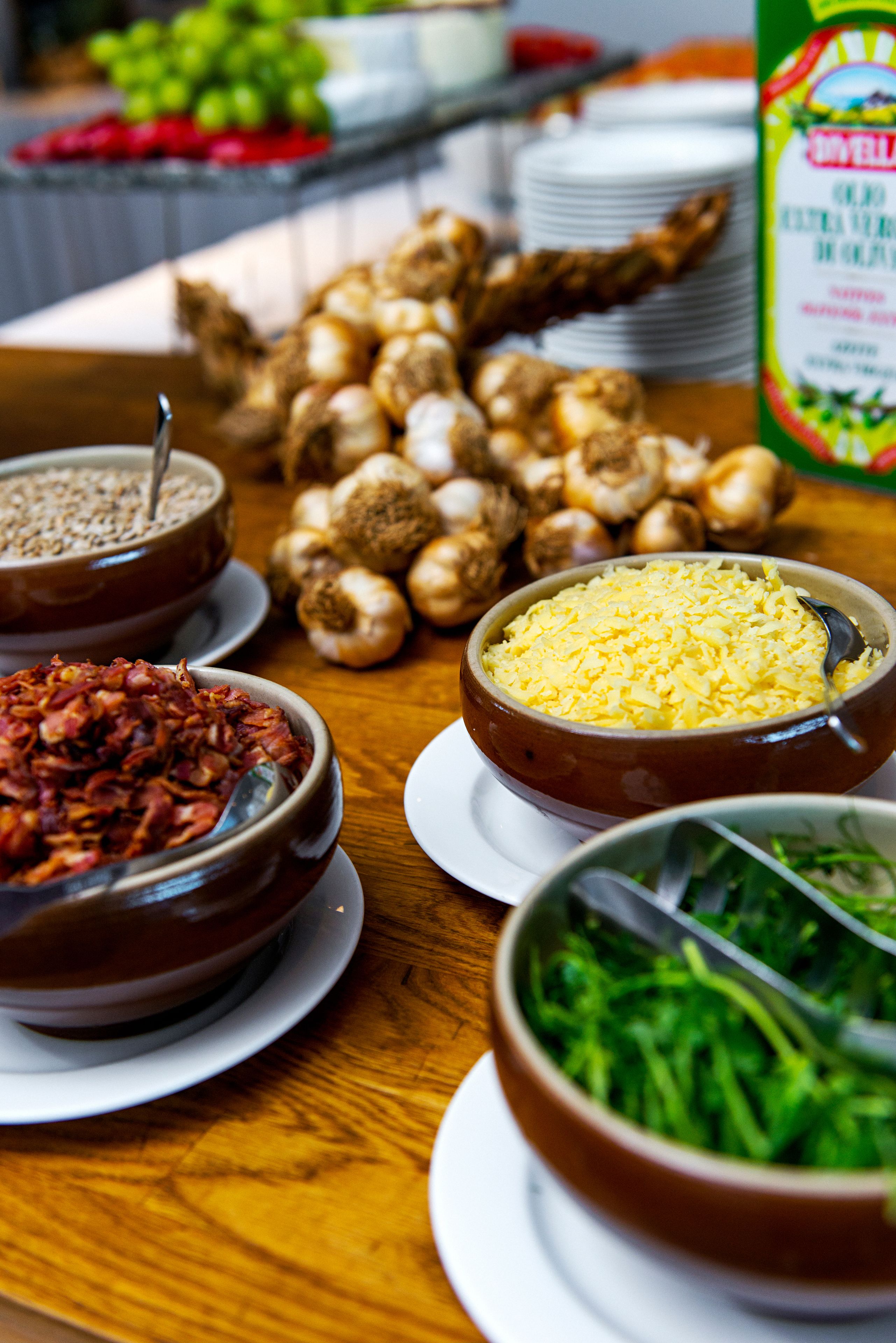 A buffet table with various food items including bowls of rice, vegetables, and other dishes.