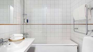 A modern bathroom with a white sink, a bathtub, and a shower.