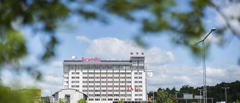 A large, multi-story building with the name "Scandic" on the top.
