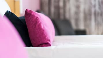 A bed with pillows in a hotel room.