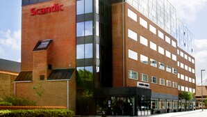 A modern hotel with a glass facade, a prominent 'Scandic' sign, and a brick base. - Scandic Olympic (Esbjerg)