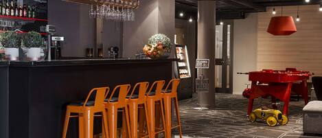A bar area with stools, a counter, and a red toy car.