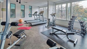 A gym with treadmills, dumbbells, and weight machines. - Scandic Södertälje (Sodertalje)