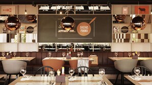 A restaurant interior with booths, tables, and hanging disco balls.
