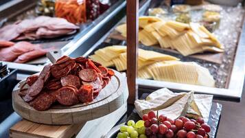 Indulge in a selection of cured meats, cheeses, and fresh grapes.