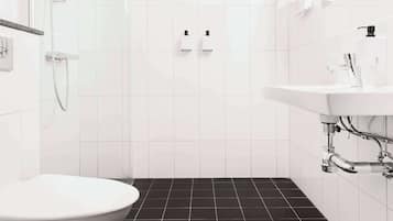 Un baño moderno con inodoro, ducha y lavamanos.